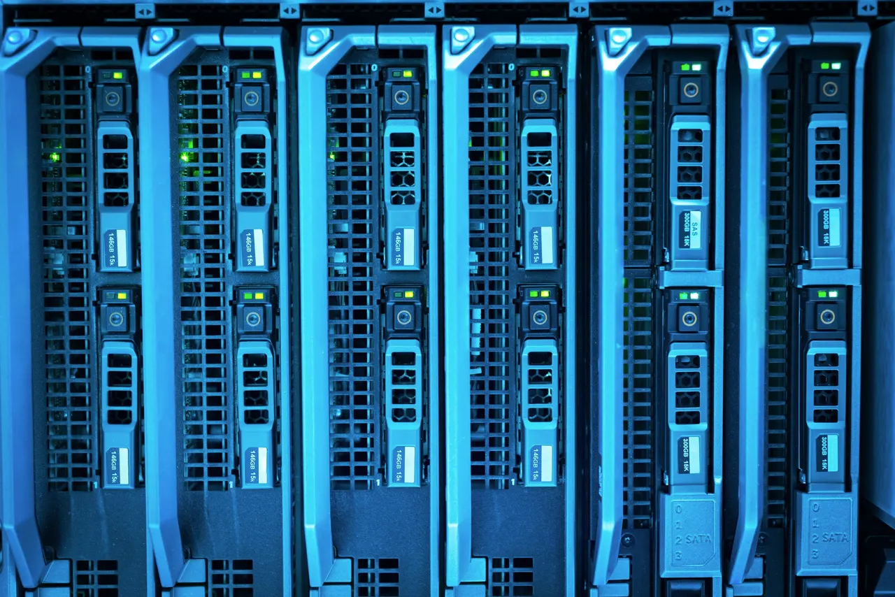 A column of blade servers lit blue, each with its own drive bays and status lights